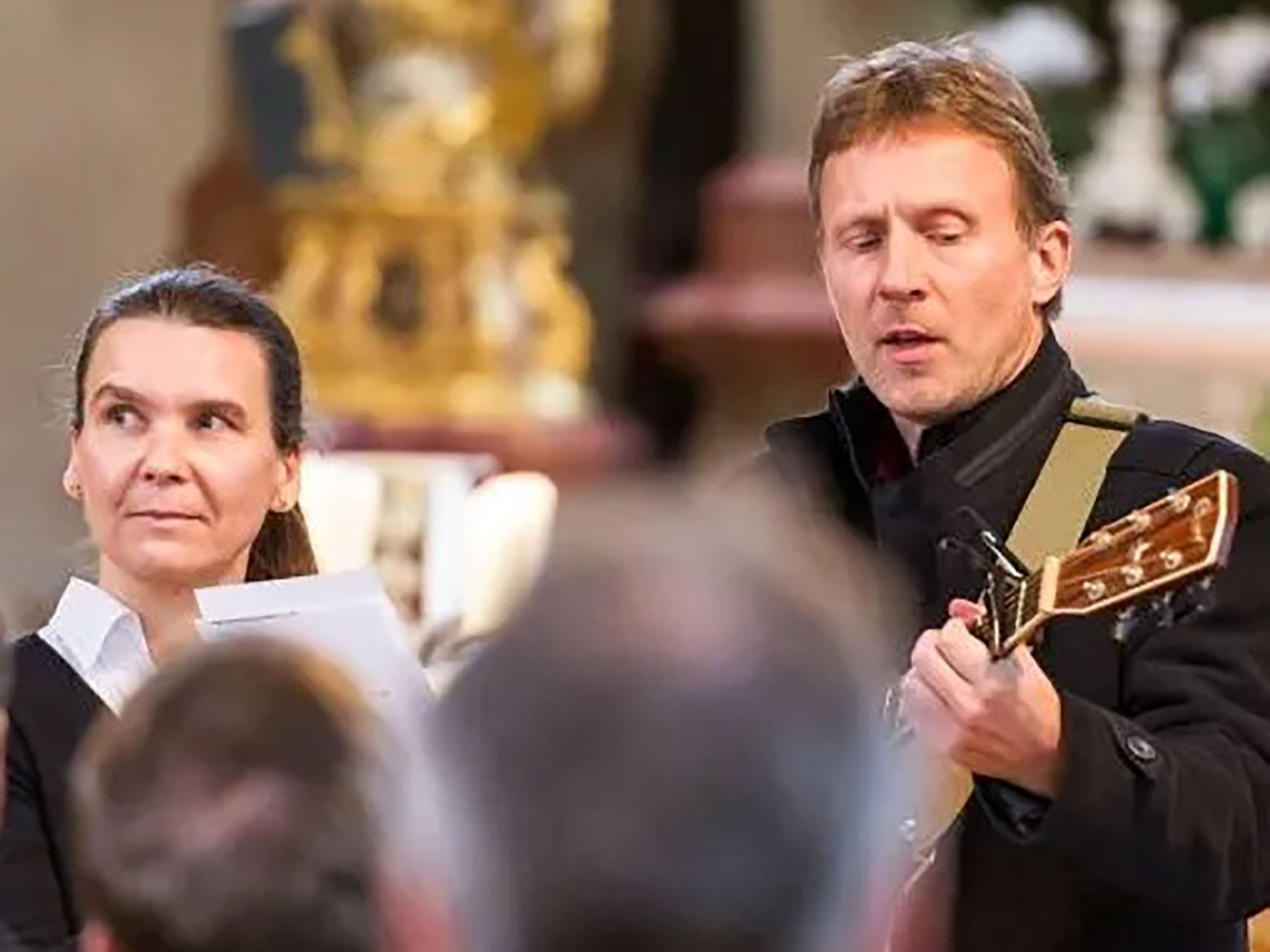 Musizieren in der Kirche - Nahaufnahme eines Mannes mit Gitarre